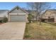 Charming home featuring an attached two-car garage and traditional landscaping at 4933 Altura St, Denver, CO 80239