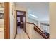 Hallway with skylight leading to a bedroom, next to a full bathroom at 4933 Altura St, Denver, CO 80239