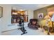 Cozy living room featuring open view to kitchen, recliner, and exercise bike at 4933 Altura St, Denver, CO 80239