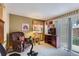 Cozy living room with recliner, TV, and sliding glass door at 4933 Altura St, Denver, CO 80239