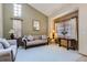 Bright living room features high ceilings, neutral walls, plush carpeting, and comfortable seating at 4933 Altura St, Denver, CO 80239