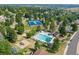 A scenic aerial view reveals a community pool, tennis courts, playground and plenty of trees at 7426 S Hudson Way, Centennial, CO 80122