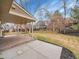 A covered back patio with brick flooring leads to a spacious yard and outdoor living space at 7426 S Hudson Way, Centennial, CO 80122