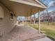 A covered back patio with brick flooring creates an ideal outdoor living space at 7426 S Hudson Way, Centennial, CO 80122