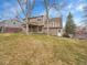 Two-story home featuring a well-maintained lawn and mature trees in the backyard at 7426 S Hudson Way, Centennial, CO 80122