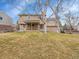 View of the home's backyard with a large grass lawn and a mature trees at 7426 S Hudson Way, Centennial, CO 80122