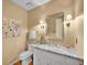 Bathroom featuring granite countertop, wood floors, and decorative sconces at 7426 S Hudson Way, Centennial, CO 80122