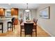 Dining room with wood table and chairs, hardwood floors, and views to the kitchen at 7426 S Hudson Way, Centennial, CO 80122