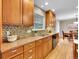 This Kitchen features light wood cabinets, hardwood floors, and tile backsplash at 7426 S Hudson Way, Centennial, CO 80122