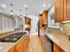 Spacious kitchen featuring custom cabinetry, granite countertops, and stainless steel appliances at 7426 S Hudson Way, Centennial, CO 80122