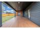 Spacious covered back porch with wood floors, a view of the backyard, and sliding glass doors at 3350 S Eudora St, Denver, CO 80222