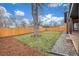 Back yard features a large tree, wood fence and well-manicured lawn at 3350 S Eudora St, Denver, CO 80222