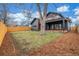 Back yard with large shade tree. Exterior is dark colored siding at 3350 S Eudora St, Denver, CO 80222