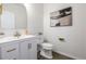 Stylish half bathroom with modern fixtures, decorative mirror, and elegant finishes at 3350 S Eudora St, Denver, CO 80222