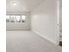 Bright, neutral bedroom with large windows and an adjoining bathroom at 3350 S Eudora St, Denver, CO 80222