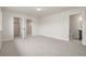 Bedroom featuring bright neutral walls, carpet, and attached closet and bathroom at 3350 S Eudora St, Denver, CO 80222