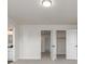 A carpeted bedroom with an open doorway view to a modern bathroom at 3350 S Eudora St, Denver, CO 80222
