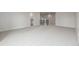 Spacious room with gray carpeting and hallway view with laundry appliances at 3350 S Eudora St, Denver, CO 80222
