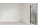 Bright bedroom with sliding glass door and view to trees and an outdoor deck at 3350 S Eudora St, Denver, CO 80222