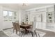 Dining area with a wooden table, upholstered chairs, a geometric rug and large built-in cabinets at 3350 S Eudora St, Denver, CO 80222