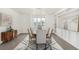 Bright dining area featuring wood table, upholstered chairs, patterned rug, and built in cabinets at 3350 S Eudora St, Denver, CO 80222