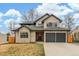 Beautiful two-story home featuring a stone and stucco facade, two-car garage, and manicured lawn at 3350 S Eudora St, Denver, CO 80222