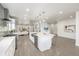 Open concept kitchen with stainless steel appliances, a large island, and modern finishes at 3350 S Eudora St, Denver, CO 80222