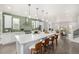 Open kitchen with white cabinets, stainless steel appliances, large island and green backsplash at 3350 S Eudora St, Denver, CO 80222