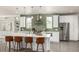 Bright kitchen with white cabinets, stainless steel appliances, a large island and unique backsplash at 3350 S Eudora St, Denver, CO 80222