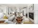 Bright living room with comfortable seating, fireplace, modern decor and open access to the kitchen at 3350 S Eudora St, Denver, CO 80222