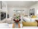 Bright living room features a fireplace, modern furniture, and large windows at 3350 S Eudora St, Denver, CO 80222
