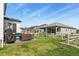 Manicured backyard offering outdoor seating, privacy fence, and lush green space at 5446 Coltin Trl, Castle Rock, CO 80104