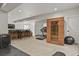 Open basement featuring sauna, treadmill, bar seating, and a comfortable living area with TV at 5446 Coltin Trl, Castle Rock, CO 80104