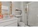 Bright and airy bathroom with white tile shower, vanity, and gold-framed mirror at 5446 Coltin Trl, Castle Rock, CO 80104