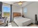 Inviting bedroom with a wooden headboard, natural light from windows, and a dedicated desk space at 5446 Coltin Trl, Castle Rock, CO 80104
