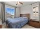 Cozy bedroom featuring a wooden headboard, a large window, and a view of the neighborhood at 5446 Coltin Trl, Castle Rock, CO 80104
