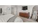 Stylish bedroom featuring a modern dresser, TV, and ensuite bathroom with a view into the bedroom at 5446 Coltin Trl, Castle Rock, CO 80104