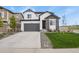 Charming two-story home with stone accents, a gray garage door, and well-maintained landscaping at 5446 Coltin Trl, Castle Rock, CO 80104
