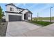 Attractive home with a stone facade, gray garage door, and a well-manicured lawn at 5446 Coltin Trl, Castle Rock, CO 80104