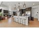 Modern open-concept kitchen with a center island, pendant lighting, and stainless steel appliances at 5446 Coltin Trl, Castle Rock, CO 80104