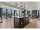 Open-concept kitchen with island, dark cabinets, white countertops, and sightlines to the dining area at 5446 Coltin Trl, Castle Rock, CO 80104
