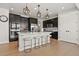 Modern kitchen with white countertops, dark cabinets, stainless steel appliances, and counter seating at 5446 Coltin Trl, Castle Rock, CO 80104