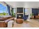 Sunlit living room with a cozy fireplace and comfortable seating arrangement at 5446 Coltin Trl, Castle Rock, CO 80104