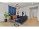 Cozy living space with stylish blue sofa and mid-century modern media cabinet at 5446 Coltin Trl, Castle Rock, CO 80104