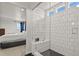 Modern shower featuring white subway tiles, black hexagon tile floor, and a built-in bench at 5446 Coltin Trl, Castle Rock, CO 80104
