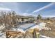 Large backyard with a covered patio, landscaping, and mountain views at 9617 Bighorn Way, Littleton, CO 80125