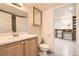 Bathroom featuring a vanity with a framed mirror, toilet, and tile flooring at 9617 Bighorn Way, Littleton, CO 80125