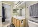 Bathroom featuring a single sink vanity with a large mirror and a view into the bedroom at 9617 Bighorn Way, Littleton, CO 80125