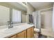 Cozy bathroom featuring a single sink vanity, a large mirror, and a shower-tub combination at 9617 Bighorn Way, Littleton, CO 80125