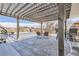 Covered patio with wooden pergola, outdoor furniture, and peaceful setting at 9617 Bighorn Way, Littleton, CO 80125